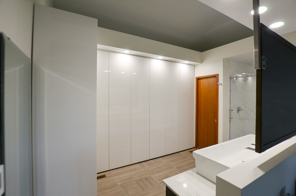 Design ideas for a large contemporary dressing room in Other with flat-panel cabinets, white cabinets and carpet.