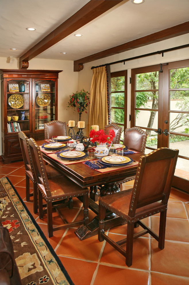This is an example of a large mediterranean dining room in Los Angeles with beige walls and terra-cotta floors.
