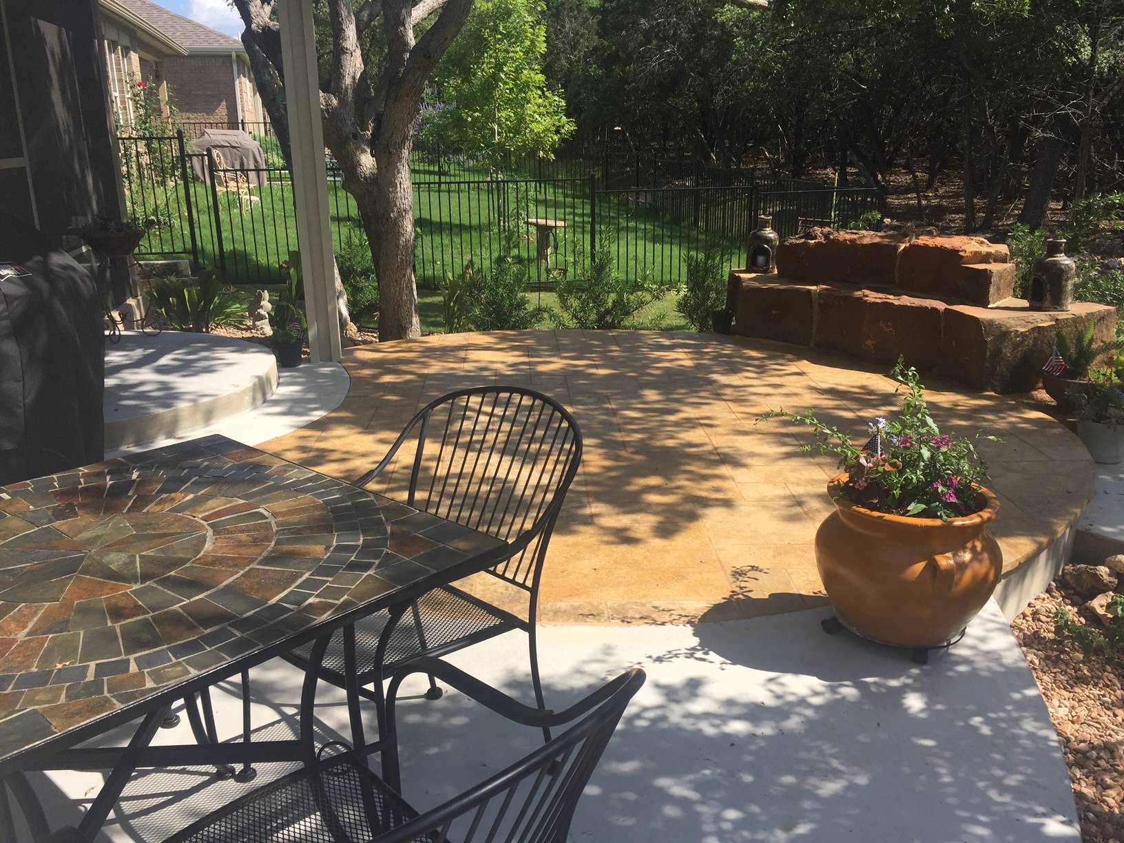 New concrete w/ stained leuders patio, large custom sandstone boulders