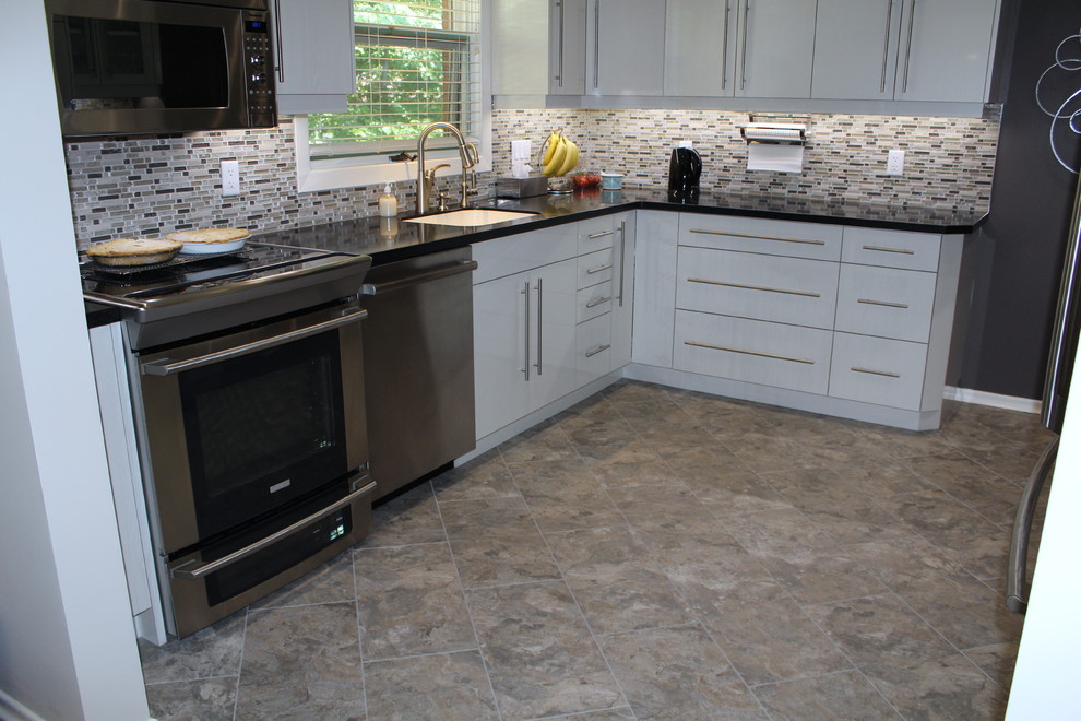 Kitchen - transitional vinyl floor kitchen idea in Toronto with white cabinets, multicolored backsplash and mosaic tile backsplash