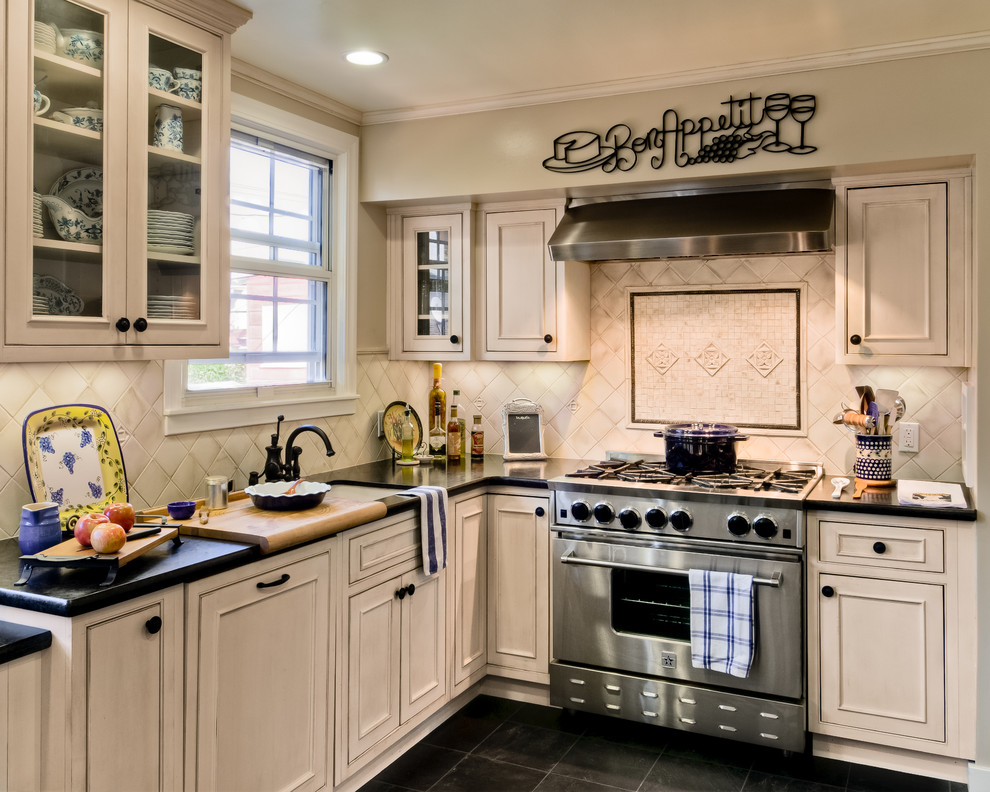Photo of a traditional kitchen in San Francisco with an undermount sink, beaded inset cabinets, distressed cabinets, white splashback, panelled appliances and slate floors.