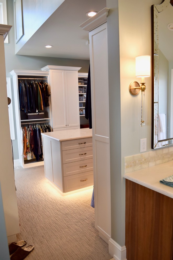 Inspiration for a mid-sized transitional gender-neutral walk-in wardrobe in Other with shaker cabinets, white cabinets, carpet and beige floor.