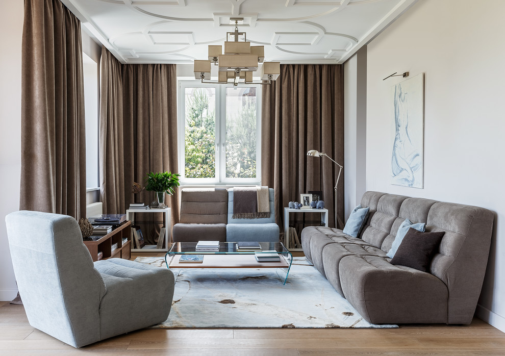 This is an example of a large contemporary open concept living room in Moscow with a library, beige walls, medium hardwood floors, no fireplace, no tv and brown floor.