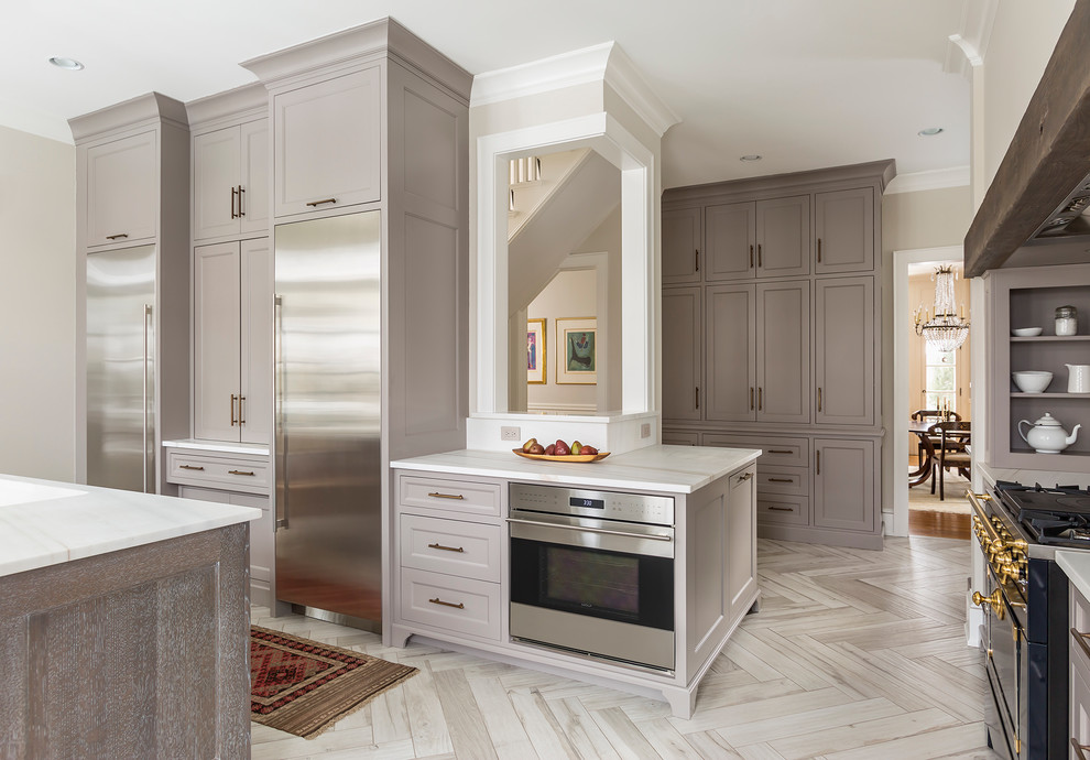 Design ideas for a large l-shaped eat-in kitchen in Minneapolis with an undermount sink, recessed-panel cabinets, grey cabinets, marble benchtops, coloured appliances, porcelain floors and with island.