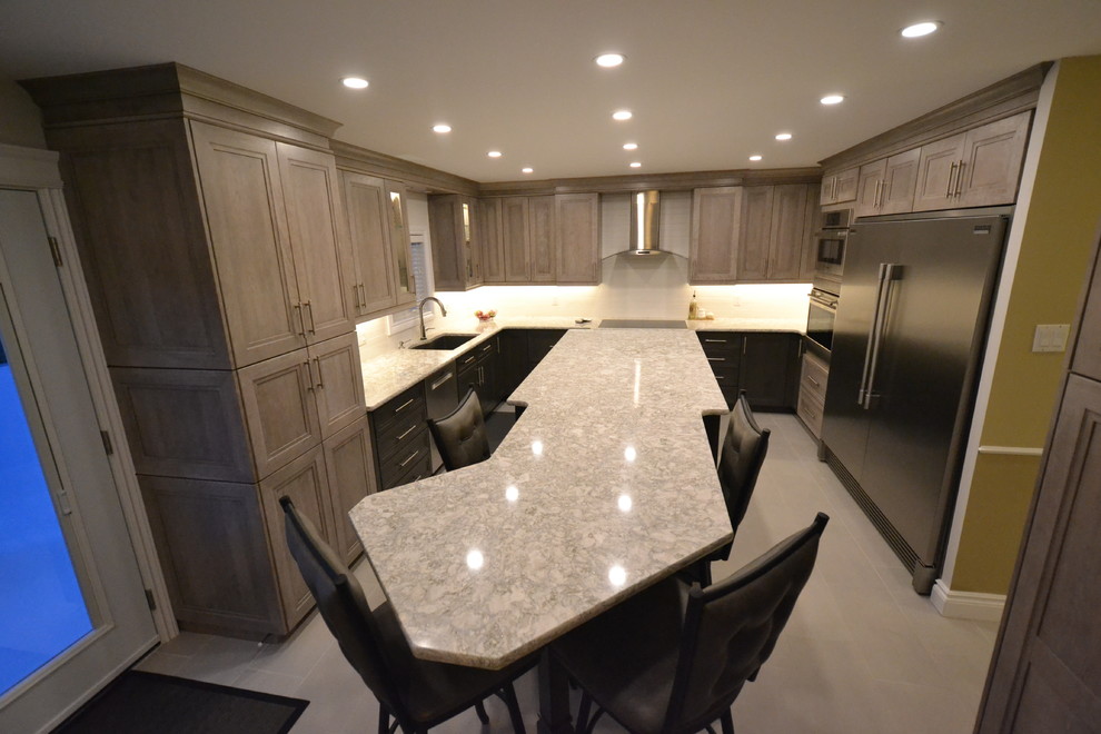Inspiration for a mid-sized transitional u-shaped eat-in kitchen remodel in Ottawa with recessed-panel cabinets and an island