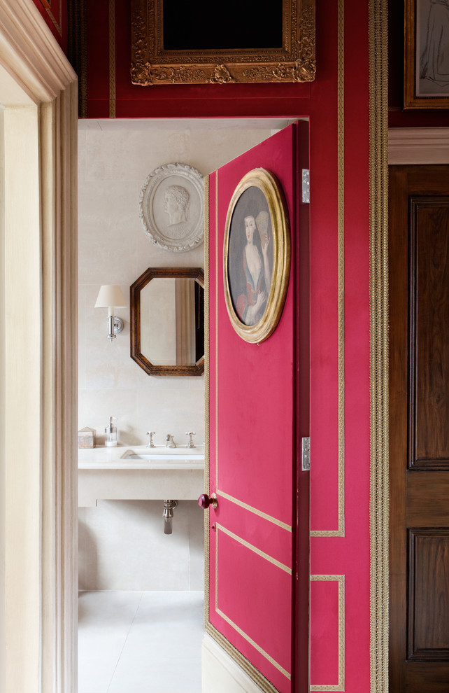 Traditional powder room in London with an undermount sink and beige walls.