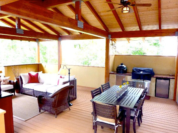 Outdoor kitchen deck - large transitional backyard outdoor kitchen deck idea in Boise with a roof extension
