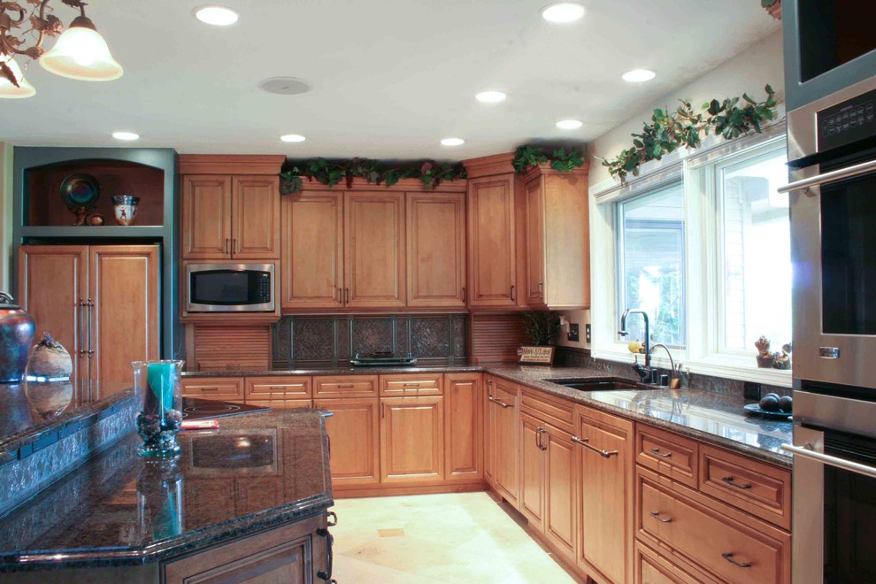 Example of a large transitional l-shaped ceramic tile eat-in kitchen design in Seattle with an undermount sink, medium tone wood cabinets, granite countertops, beige backsplash, ceramic backsplash, stainless steel appliances and an island