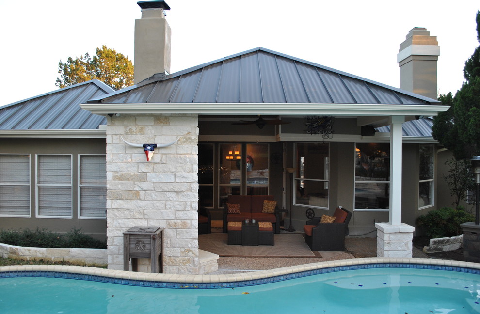 Design ideas for a mid-sized country backyard kidney-shaped pool in Austin with stamped concrete.