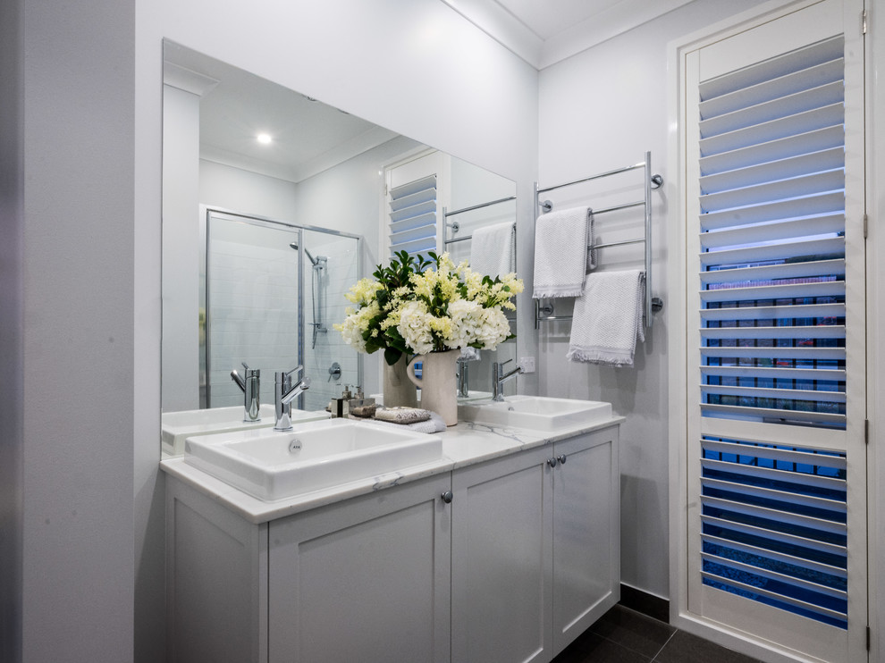 Mid-sized contemporary master bathroom in Hobart with shaker cabinets, white cabinets, an undermount tub, a corner shower, white tile, ceramic tile, white walls, ceramic floors, an undermount sink, marble benchtops, grey floor, a hinged shower door and white benchtops.
