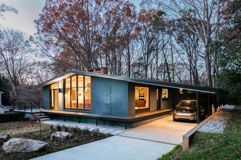 Inspiration for a midcentury one-storey brick grey house exterior in Raleigh with a gable roof.