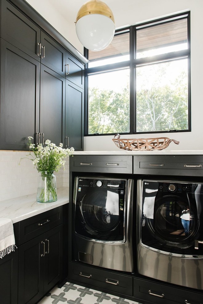 Photo of a small country l-shaped dedicated laundry room in Salt Lake City with black cabinets, marble benchtops, white walls, a side-by-side washer and dryer and multi-coloured benchtop.