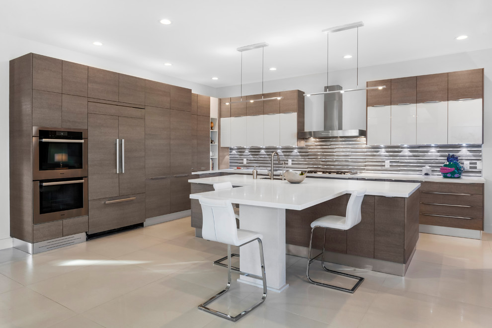Mid-sized contemporary l-shaped kitchen in Miami with an undermount sink, flat-panel cabinets, brown cabinets, metallic splashback, metal splashback, panelled appliances and beige floor.