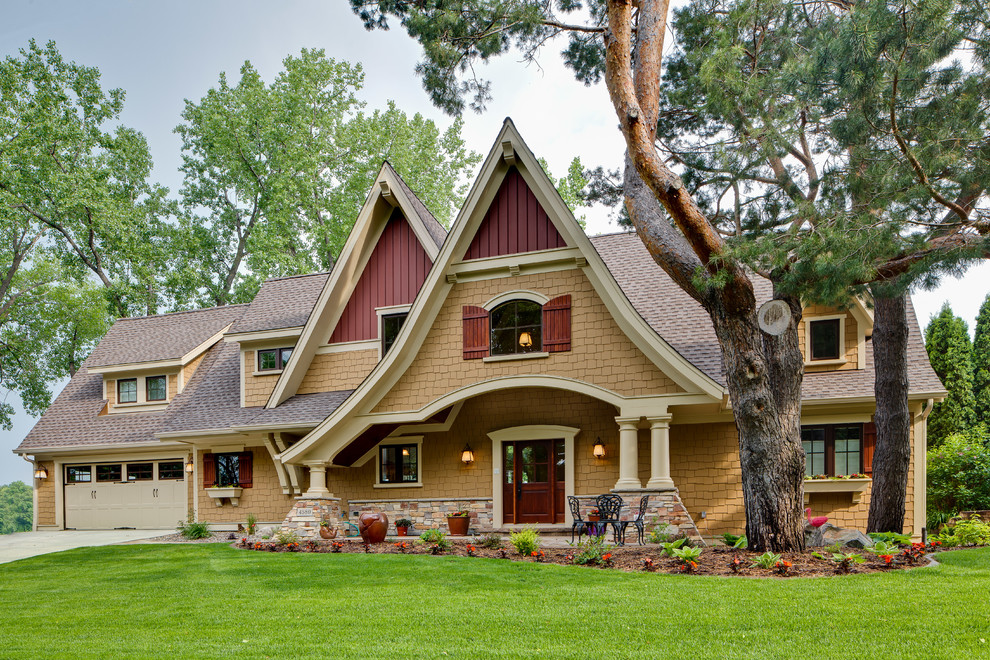 Design ideas for a traditional two-storey exterior in Minneapolis with wood siding.