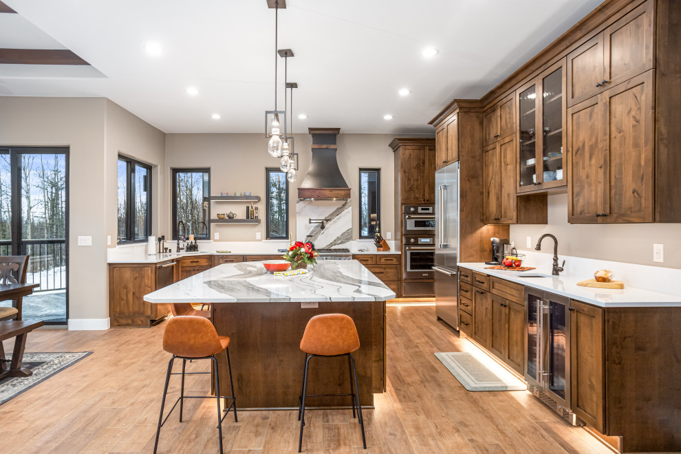 Large transitional open concept kitchen photo with shaker cabinets, quartz countertops and an island