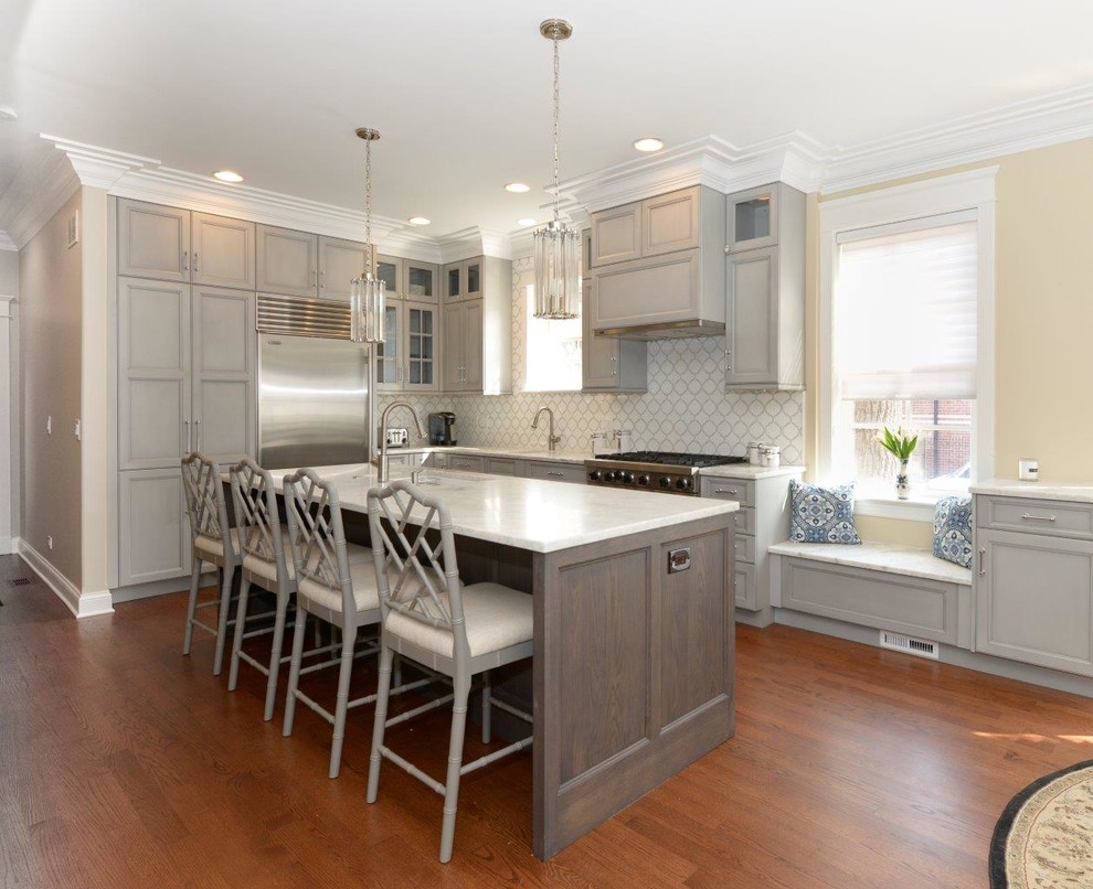 Example of a mid-sized transitional l-shaped medium tone wood floor eat-in kitchen design in Chicago with recessed-panel cabinets, gray cabinets, multicolored backsplash, an island, an undermount sink, quartzite countertops, mosaic tile backsplash and stainless steel appliances