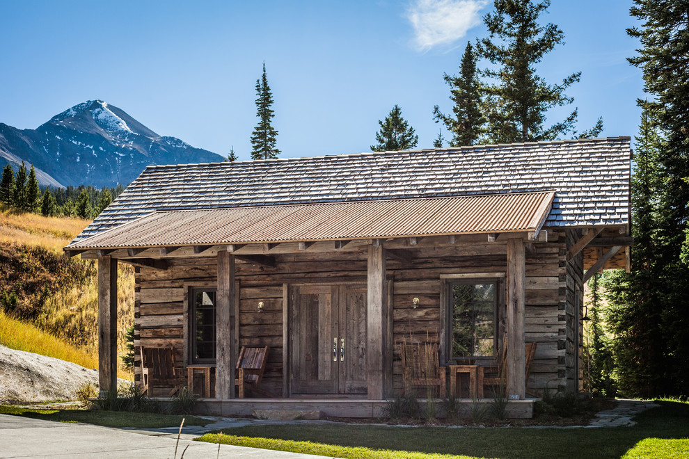 Inspiration for a mid-sized country one-storey brown exterior in Other with wood siding and a gable roof.