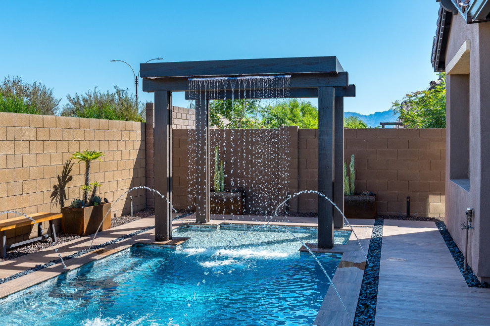 Small backyard tile and rectangular pool photo in Phoenix