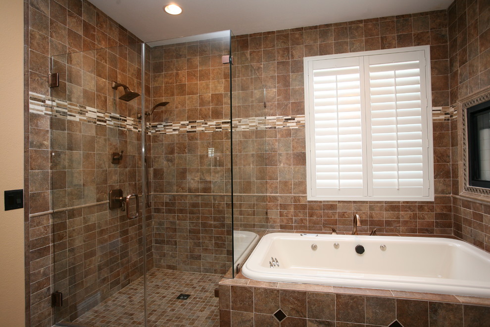This is an example of a large modern master bathroom in Orange County with an undermount sink, raised-panel cabinets, medium wood cabinets, granite benchtops, a hot tub, an open shower, a two-piece toilet, brown tile, porcelain tile, beige walls and porcelain floors.