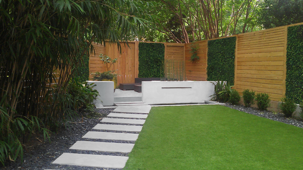 Inspiration for a small modern backyard shaded formal garden in Atlanta with a water feature.