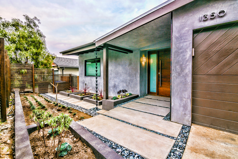 This is an example of a mid-sized contemporary partial sun garden in San Francisco with a container garden and concrete pavers.