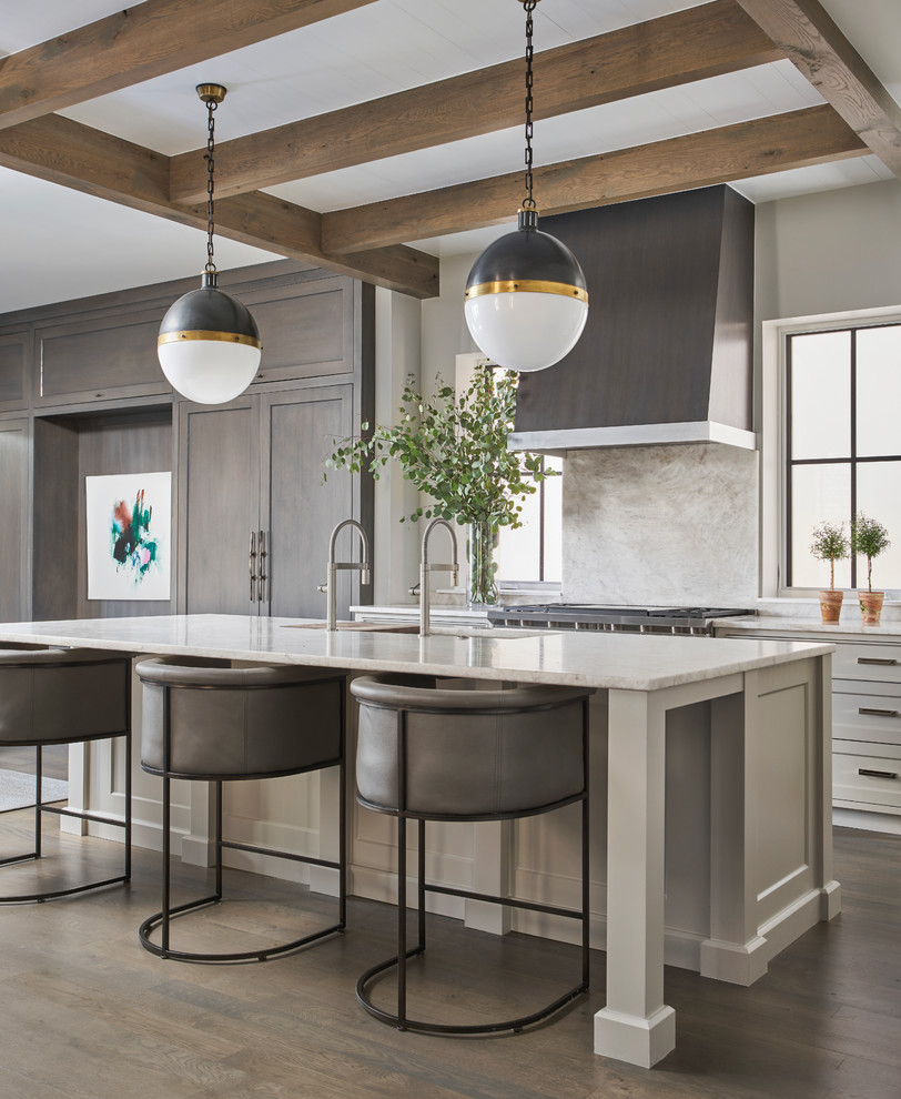 Design ideas for a large contemporary l-shaped open plan kitchen in Chicago with with island, a double-bowl sink, shaker cabinets, dark hardwood floors, brown floor, white cabinets, marble benchtops, white splashback, stone slab splashback and white benchtop.