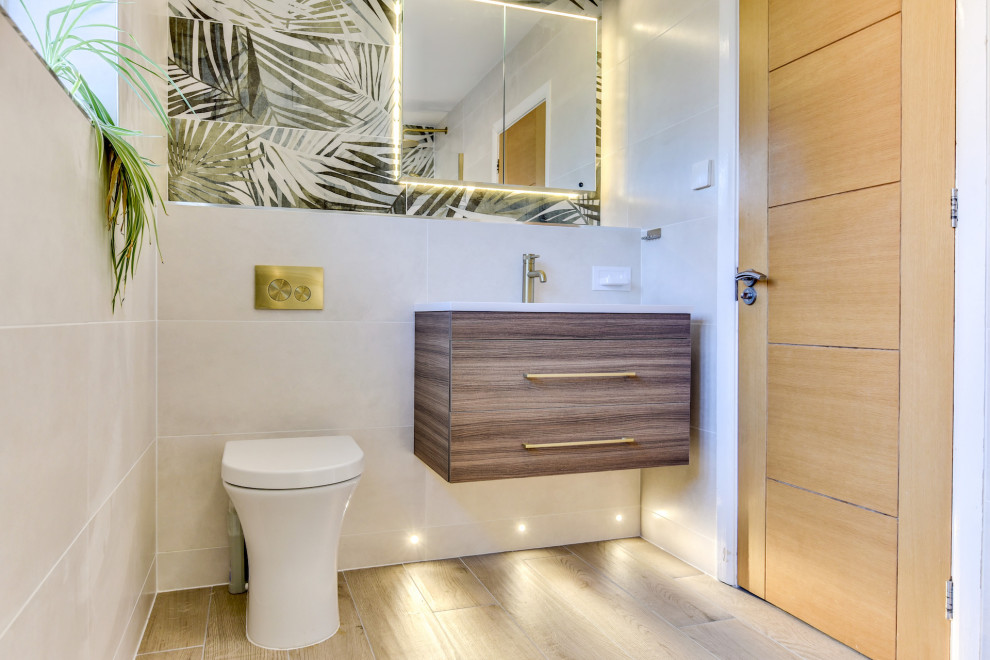 Design ideas for a mid-sized tropical master bathroom in Sussex with flat-panel cabinets, medium wood cabinets, an open shower, a two-piece toilet, beige tile, ceramic tile, beige walls, wood-look tile, a drop-in sink, tile benchtops, brown floor, beige benchtops, a single vanity and a floating vanity.