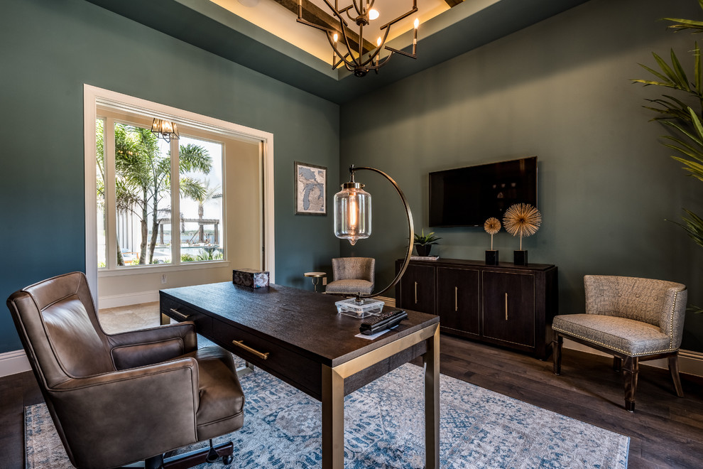 Inspiration for a large mediterranean home office in Orlando with green walls, dark hardwood floors, no fireplace, a freestanding desk and brown floor.
