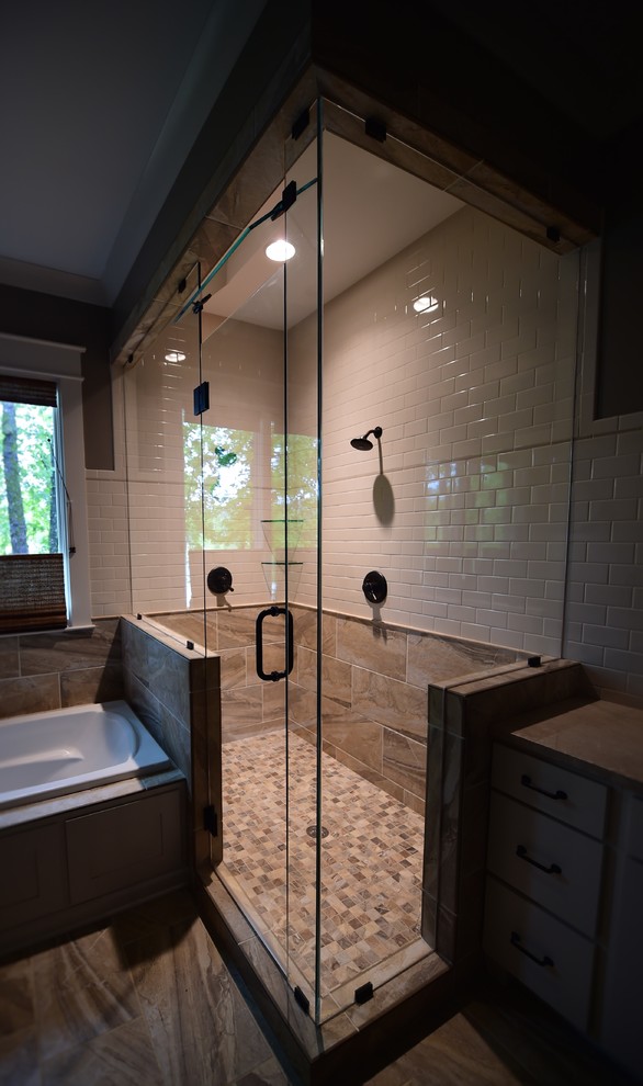 Example of a large mountain style master multicolored tile and subway tile porcelain tile drop-in bathtub design with shaker cabinets, white cabinets, granite countertops, a two-piece toilet and gray walls