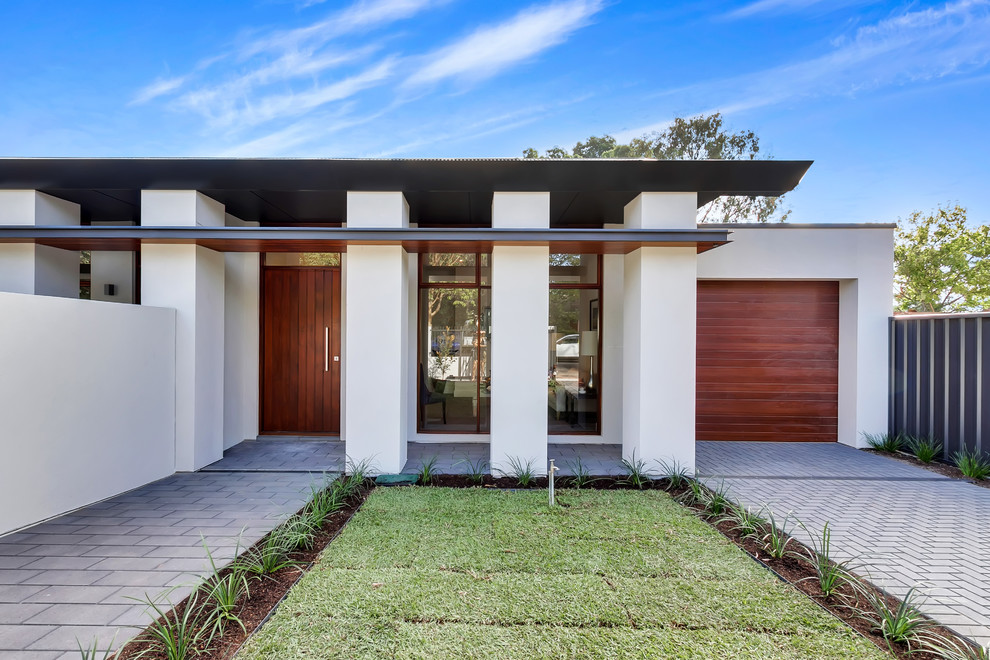 This is an example of a contemporary front door in Adelaide with brick floors, a single front door, a medium wood front door and grey floor.