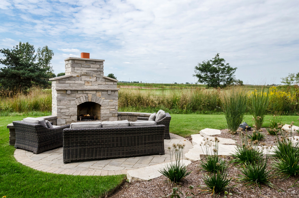 Inspiration for a large transitional backyard patio in Chicago with a fire feature, brick pavers and a pergola.