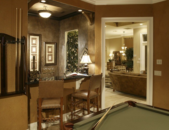 Large mediterranean open concept family room in Orlando with a game room, brown walls and carpet.
