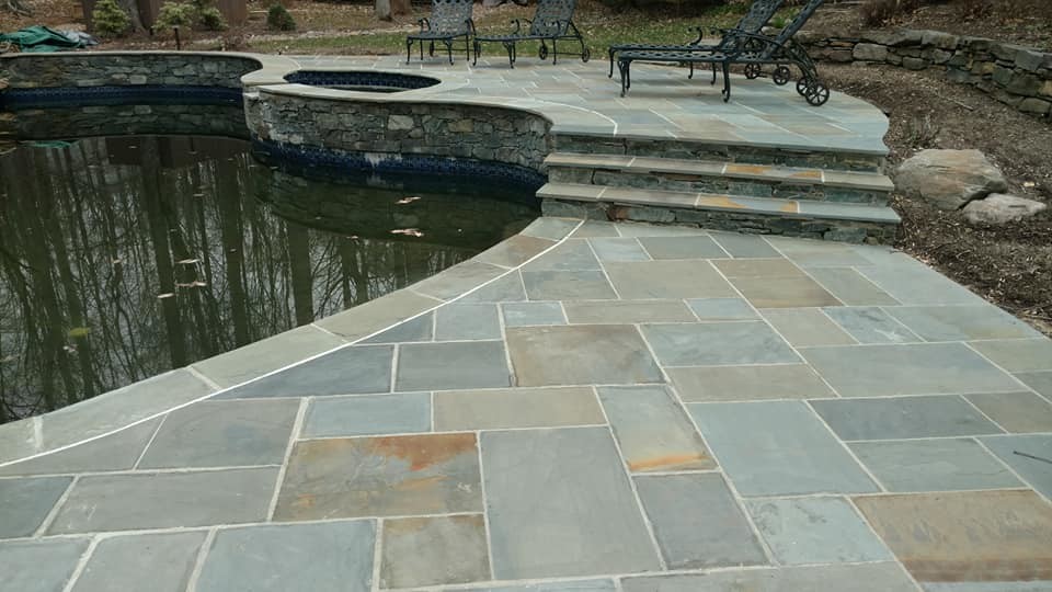 Inspiration for a huge transitional backyard stone and kidney-shaped natural pool remodel