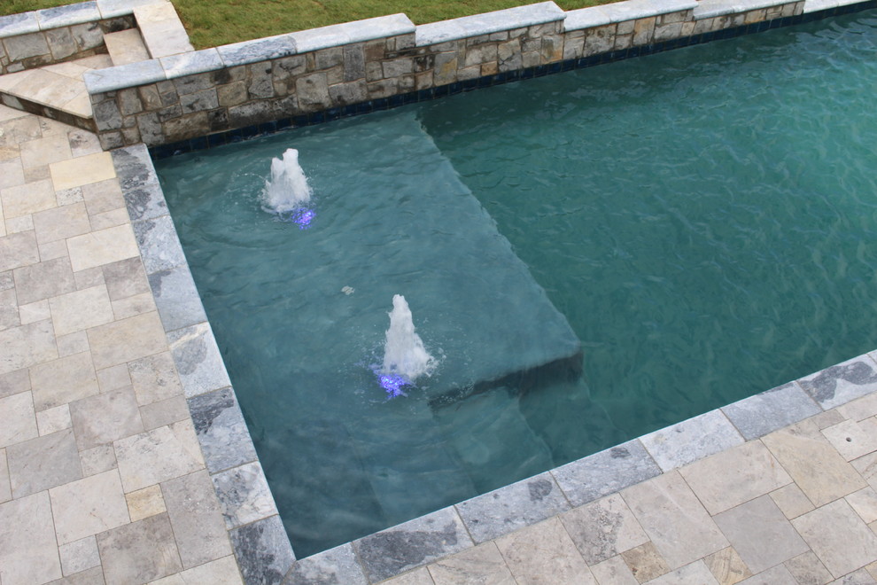 Example of a small mountain style backyard stone and rectangular natural hot tub design in DC Metro