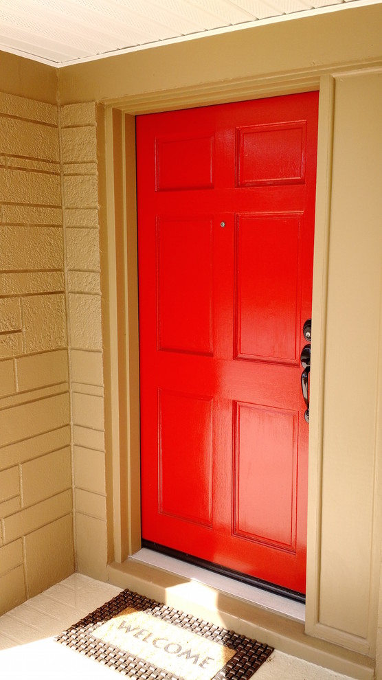 Example of a small transitional front door design in Tampa with a red front door