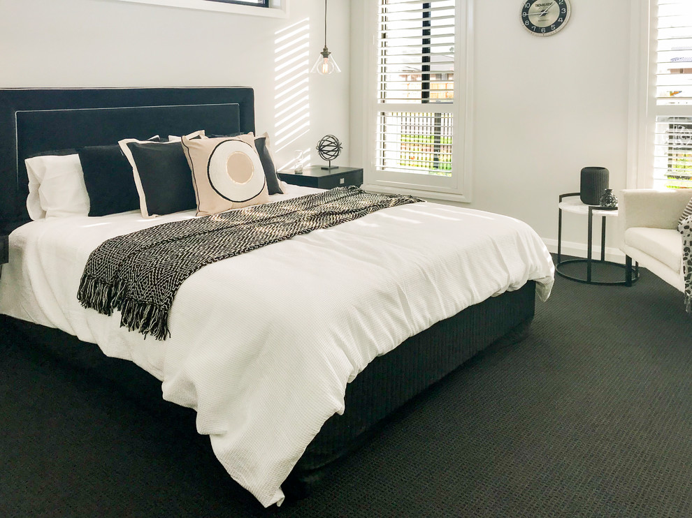 Inspiration for a contemporary master bedroom in Sydney with carpet and black floor.