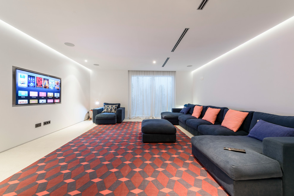 This is an example of a large modern enclosed home theatre in Other with white walls and a wall-mounted tv.