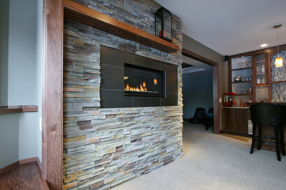 Design ideas for a large modern look-out basement in Minneapolis with blue walls, carpet, a ribbon fireplace and a stone fireplace surround.
