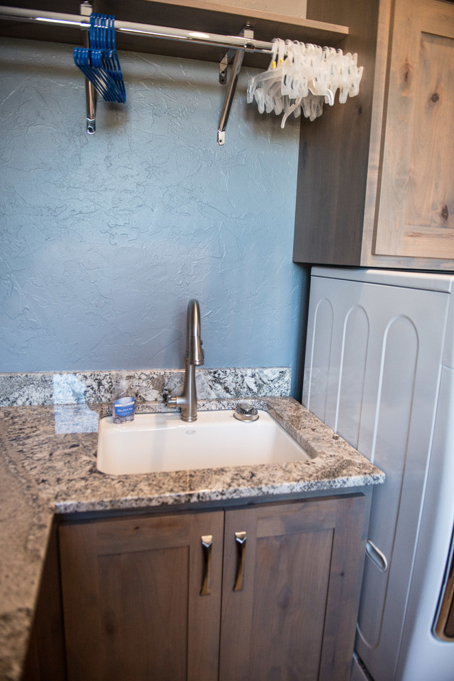 Huge mountain style u-shaped gray floor utility room photo with an undermount sink, flat-panel cabinets, light wood cabinets, granite countertops, blue walls, a side-by-side washer/dryer and multicolored countertops