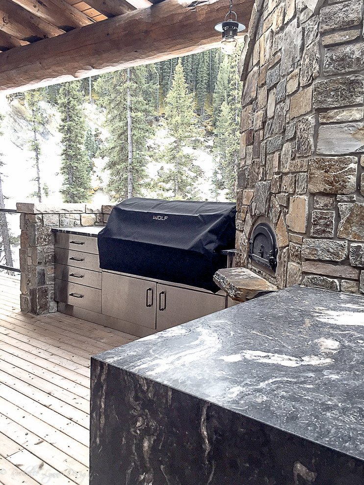 Inspiration for a rustic side yard outdoor kitchen deck remodel in Calgary