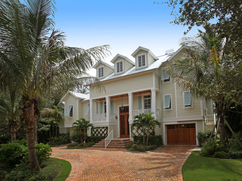 This is an example of a tropical beige exterior in Miami.