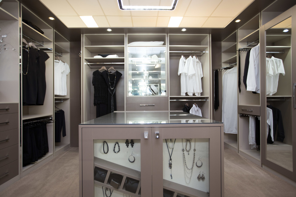 Inspiration for an expansive contemporary women's dressing room in Perth with open cabinets, grey cabinets and carpet.