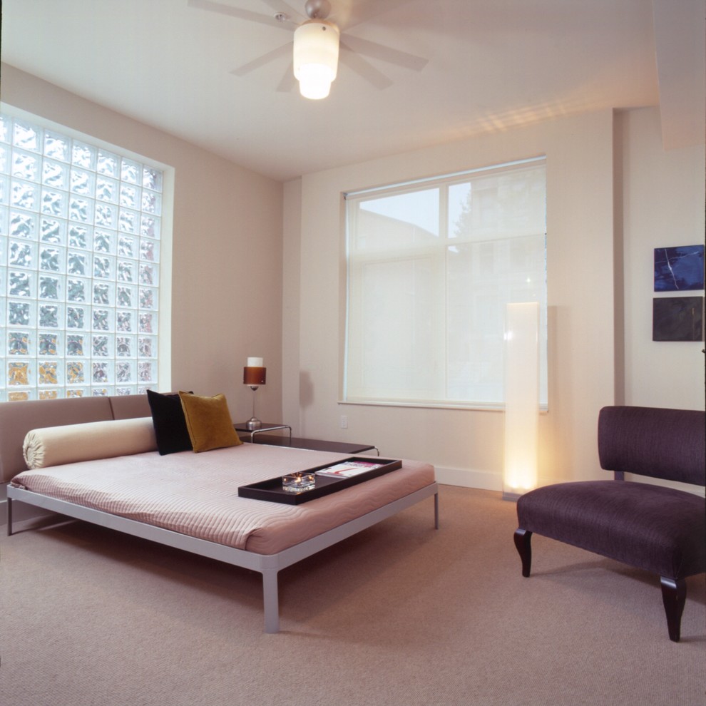 This is an example of a modern bedroom in DC Metro with pink walls, carpet and pink floor.