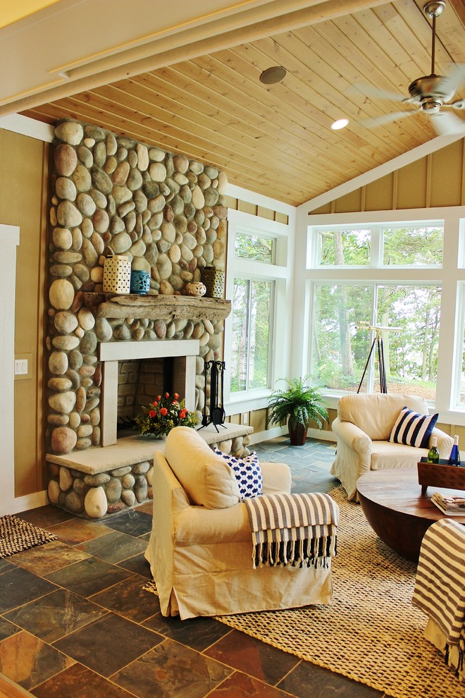 Design ideas for a beach style sunroom in Grand Rapids with slate floors and a stone fireplace surround.