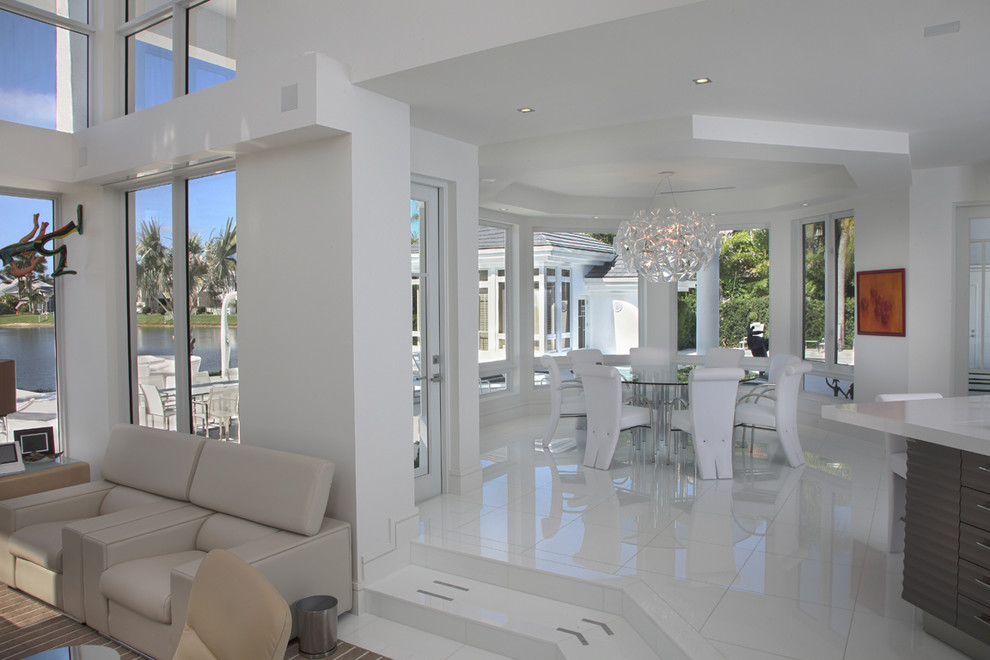 Photo of an expansive contemporary kitchen/dining combo in Miami with white walls, marble floors and no fireplace.