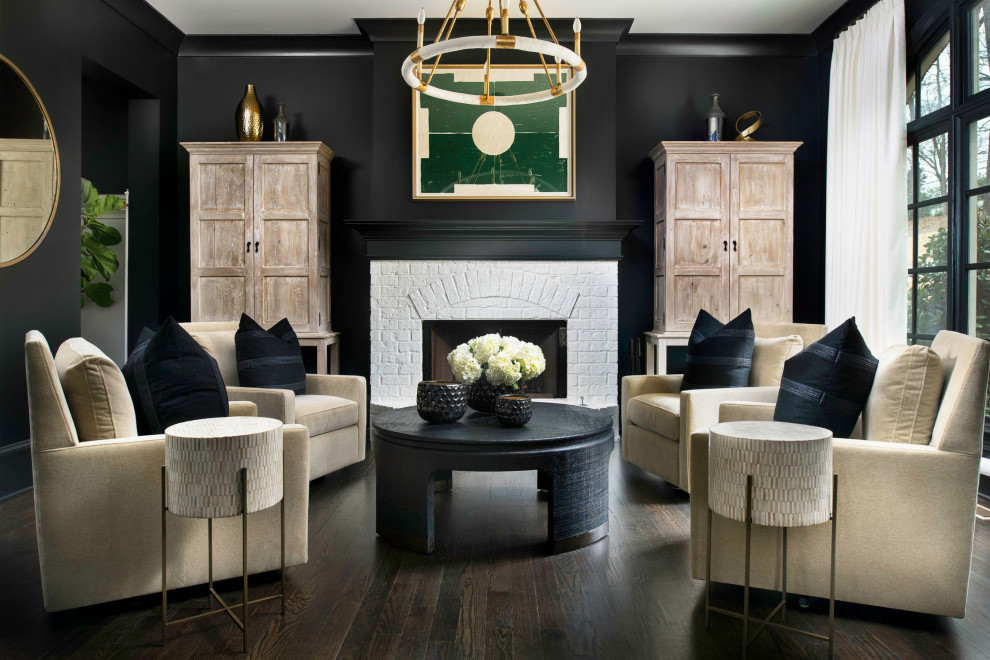Photo of a medium sized traditional cream and black enclosed living room in Atlanta with black walls, dark hardwood flooring, a standard fireplace, a brick fireplace surround, a concealed tv and brown floors.