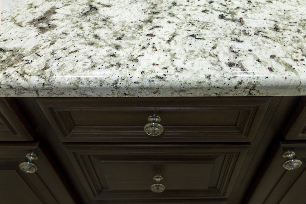 Example of a mid-sized transitional master gray tile and porcelain tile porcelain tile and brown floor home design design in Phoenix with shaker cabinets, dark wood cabinets, a one-piece toilet, beige walls, an undermount sink, granite countertops and beige countertops