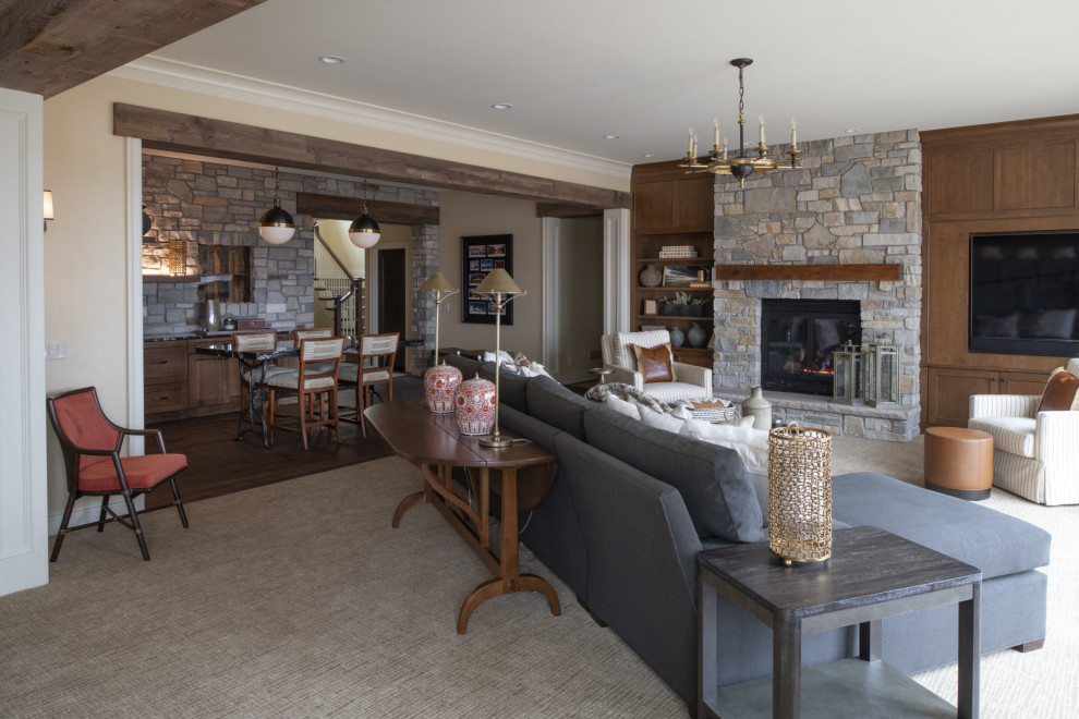 Design ideas for a large classic basement in Minneapolis with beige walls, carpet, a standard fireplace, a stacked stone fireplace surround and beige floors.