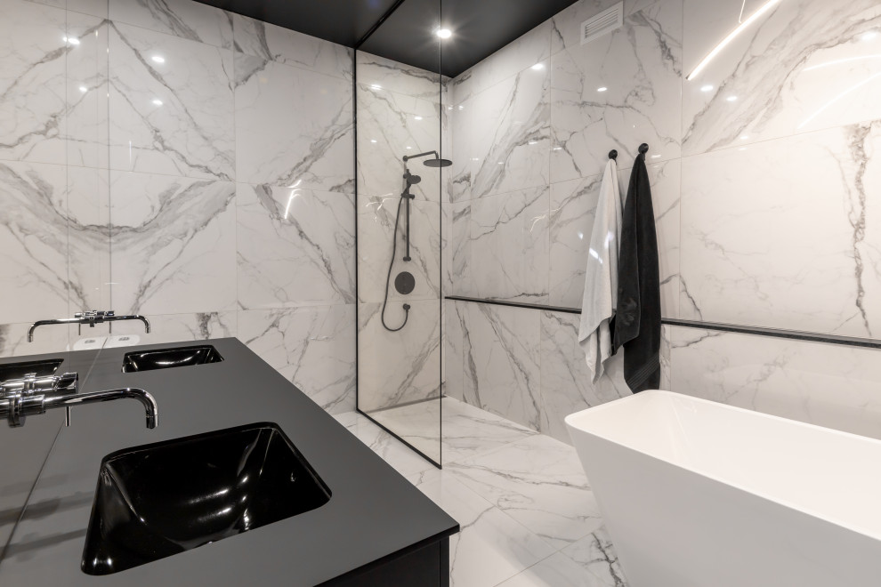 Photo of a large modern master bathroom in New York with black cabinets, a freestanding tub, an open shower, black and white tile, ceramic tile, multi-coloured walls, ceramic floors, a drop-in sink, engineered quartz benchtops, multi-coloured floor, an open shower, black benchtops and a double vanity.