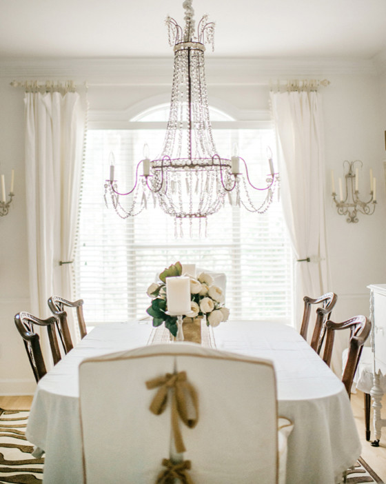 This is an example of a mid-sized mediterranean separate dining room in Jacksonville with white walls and light hardwood floors.
